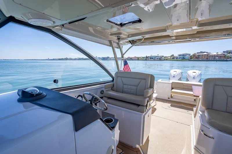 Slide: The Image of Interior view of 2019 Everglades 340 Dual Console boat on calm water. - 26