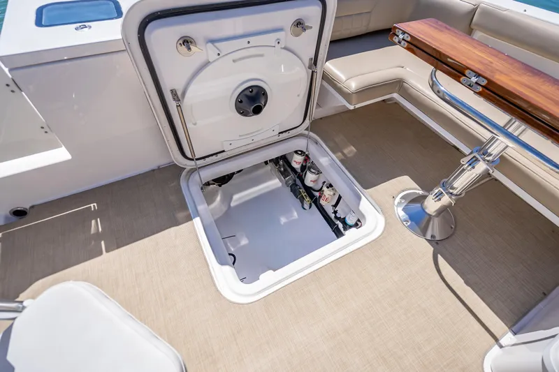 Slide: The Image of Open hatch on 2019 Everglades 340 Dual Console boat, revealing storage compartment. - 42