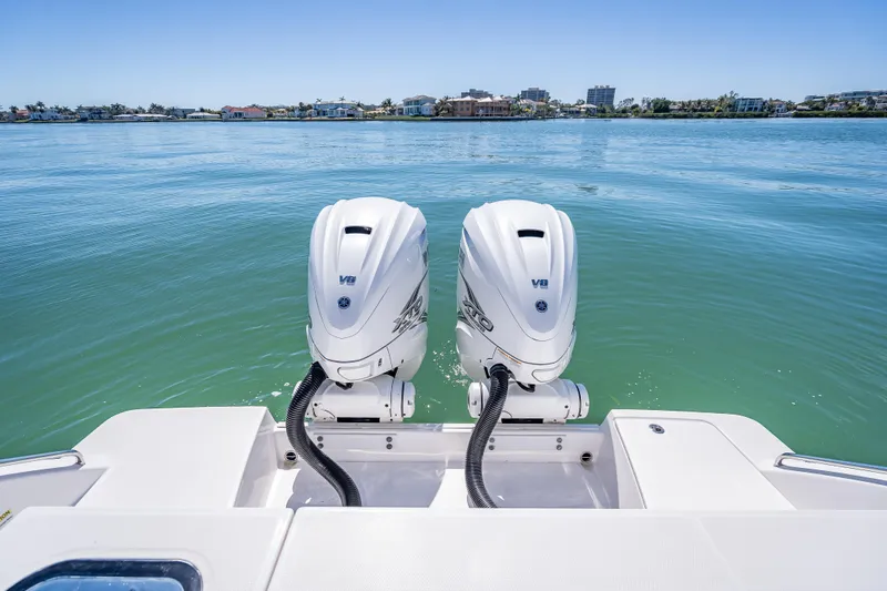 Slide: The Image of 2019 Everglades 340 Dual Console boat with twin V8 engines on calm water. - 43
