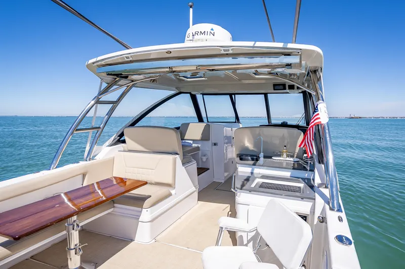 Slide: The Image of 2019 Everglades 340 Dual Console boat interior with seating and ocean view. - 47