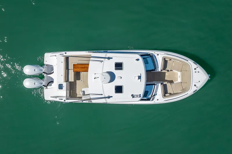 Slide: The Image of Overhead view of 2019 Everglades 340 Dual Console boat on green water. - 5