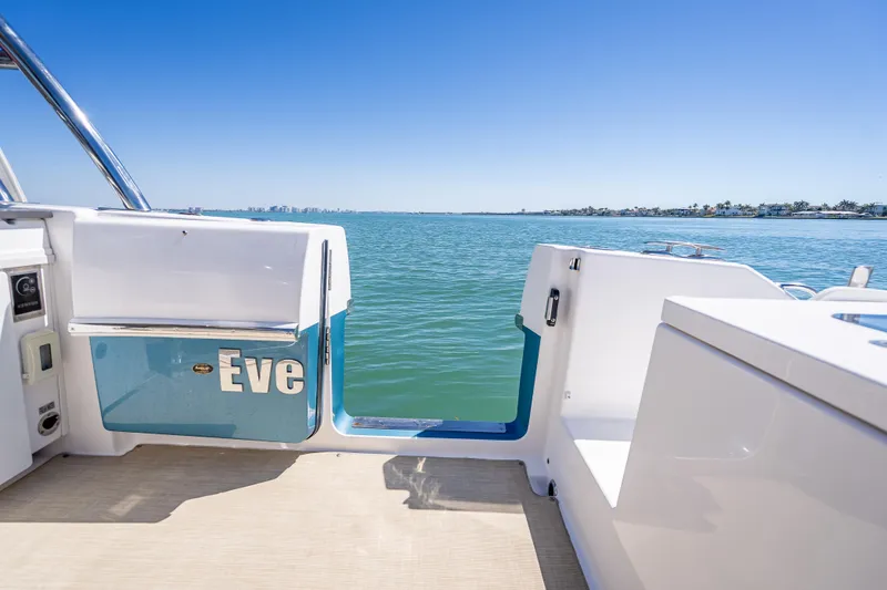 Slide: The Image of 2019 Everglades 340 Dual Console boat with open deck, overlooking serene blue waters. - 52