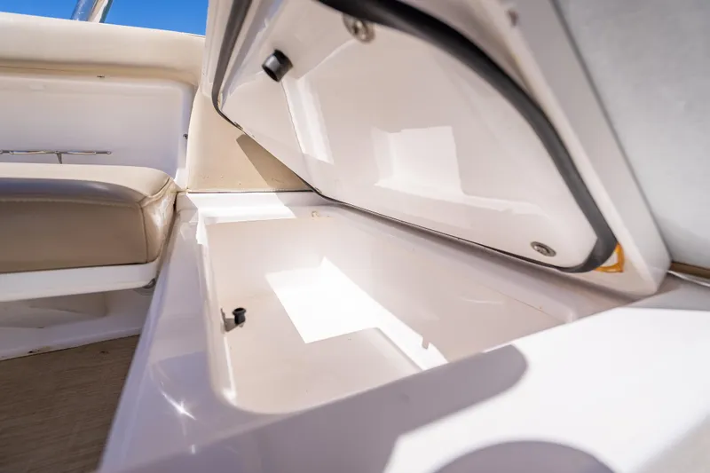 Slide: The Image of Open storage compartment on 2019 Everglades 340 Dual Console boat interior. - 53