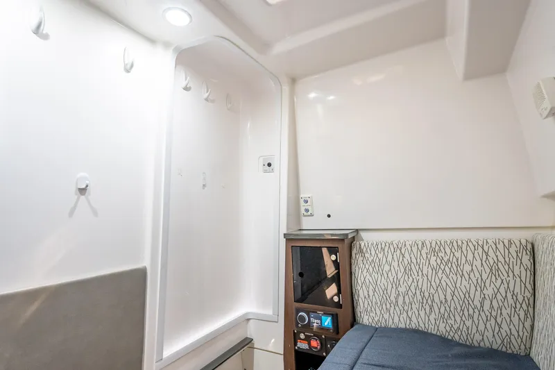 Slide: The Image of Interior cabin of 2019 Everglades 340 Dual Console boat, featuring seating and storage. - 56