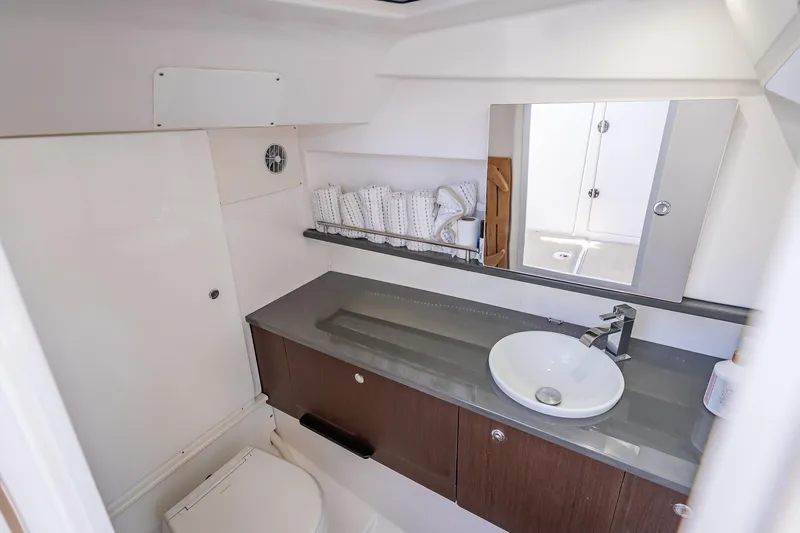 Slide: The Image of Luxurious bathroom interior of 2019 Everglades 340 Dual Console boat, featuring modern sink and mirror. - 57