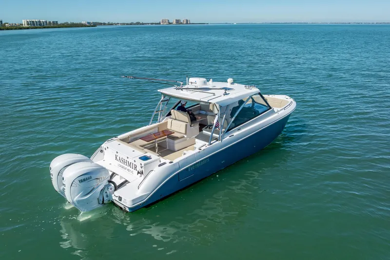 Slide: The Image of 2019 Everglades 340 Dual Console boat on calm blue water. - 6