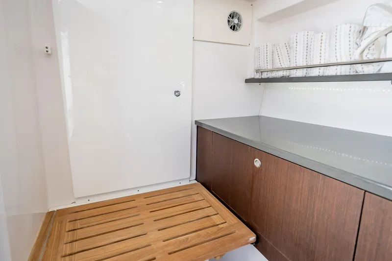 Slide: The Image of Interior of 2019 Everglades 340 Dual Console boat with wooden flooring and sleek cabinetry. - 60