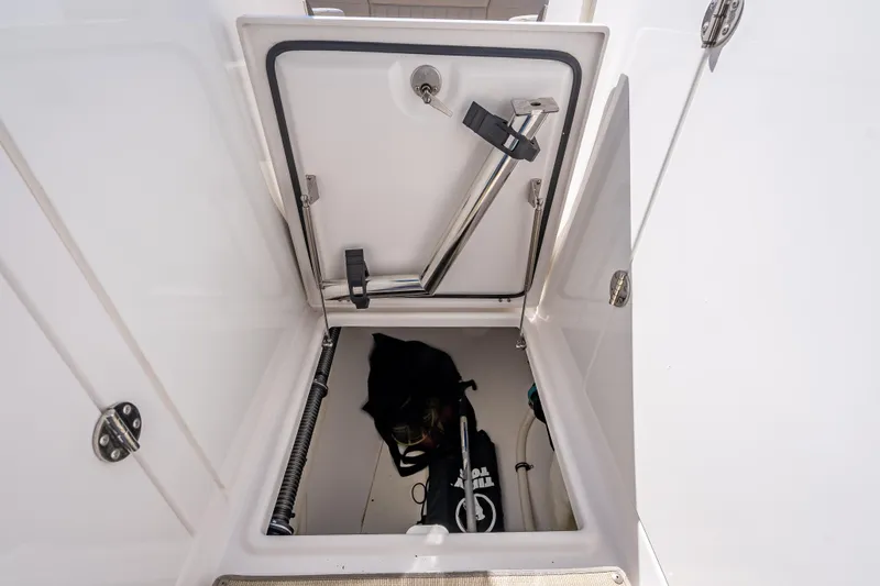 Slide: The Image of Open storage compartment on 2019 Everglades 340 Dual Console boat. - 61