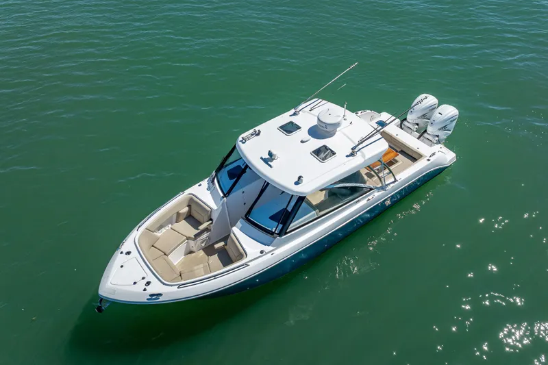 Slide: The Image of 2019 Everglades 340 Dual Console boat on clear water, aerial view. - 8
