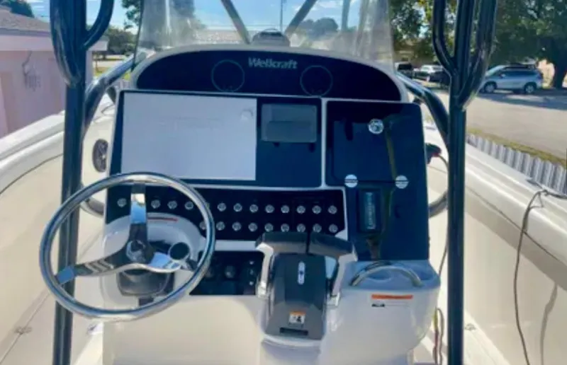 Slide: The Image of Console of a 2006 Wellcraft 32 CCF boat with steering wheel and controls. - 22