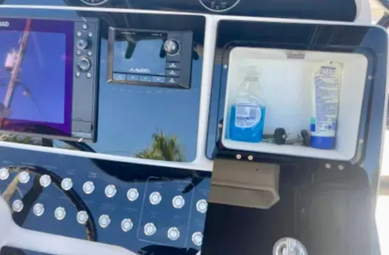 Slide: The Image of Control panel of 2006 Wellcraft 32 CCF boat with navigation and storage compartments. - 24