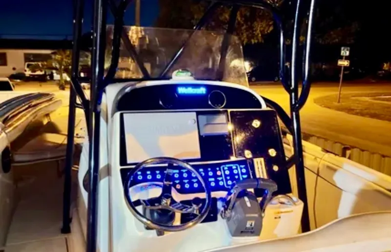 Slide: The Image of 2006 Wellcraft 32 CCF boat console at night, illuminated controls and steering wheel. - 25