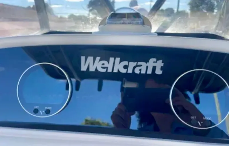 Slide: The Image of 2006 Wellcraft 32 CCF dashboard with logo and gauges. - 28
