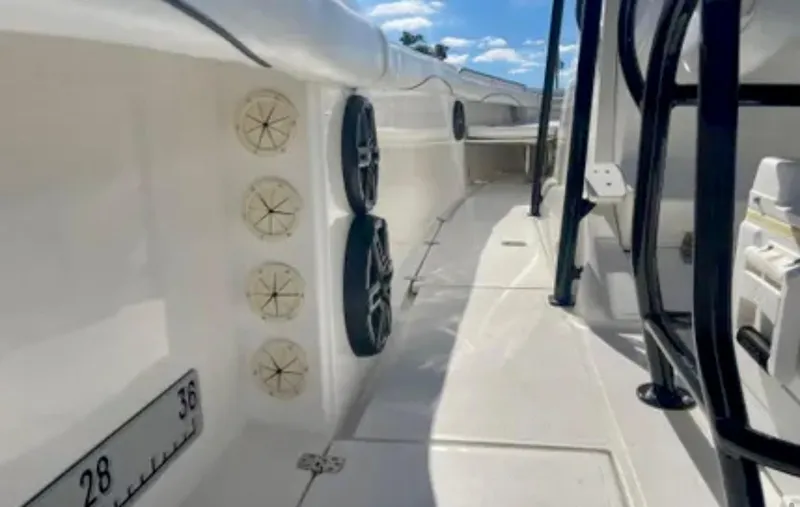 Slide: The Image of 2006 Wellcraft 32 CCF boat interior with rod holders and speakers, under a clear blue sky. - 29