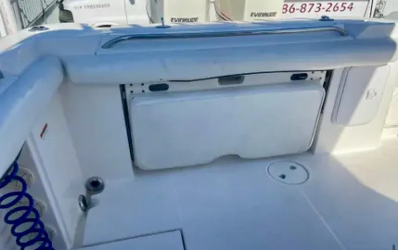 Slide: The Image of 2006 Wellcraft 32 CCF boat interior with storage compartment and clean deck. - 32