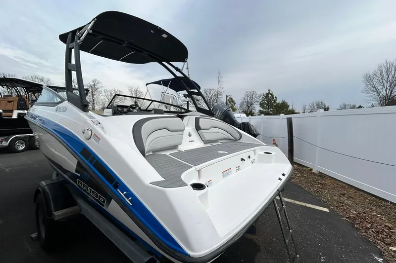 Slide: The Image of 2019 Yamaha Boats AR190 with sleek design, blue accents, and spacious seating. - 1