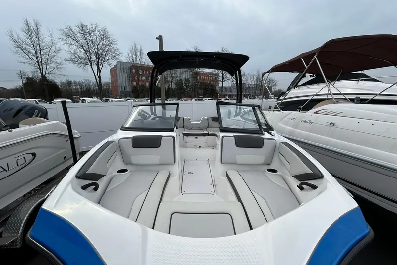 Slide: The Image of 2019 Yamaha Boats AR190, sleek design, spacious seating, docked among other boats. - 5