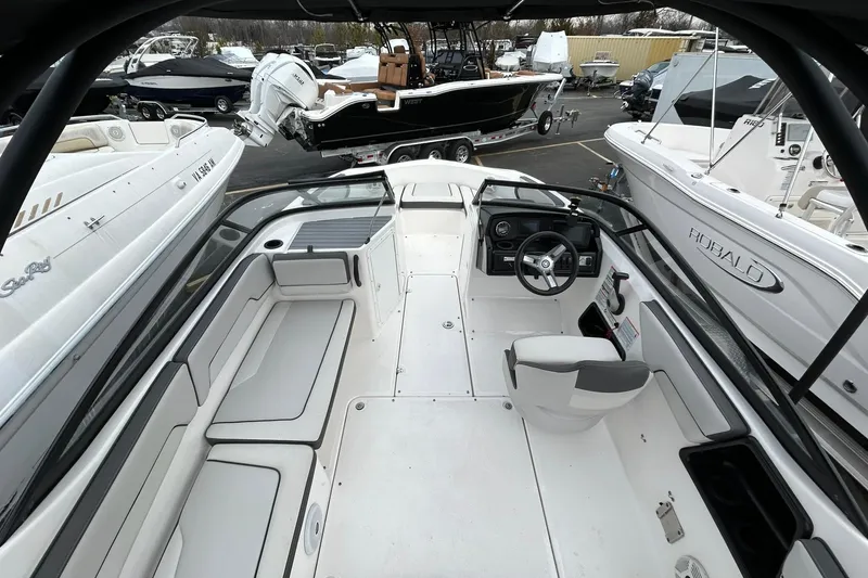Slide: The Image of 2019 Yamaha Boats AR190 interior with seating and steering wheel, surrounded by other boats. - 7