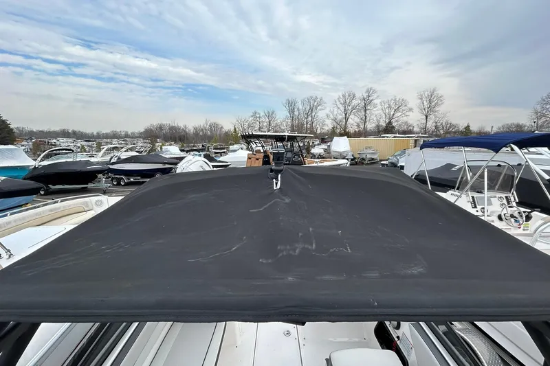 Slide: The Image of 2019 Yamaha AR190 boat with black cover, surrounded by other boats in a marina. - 8