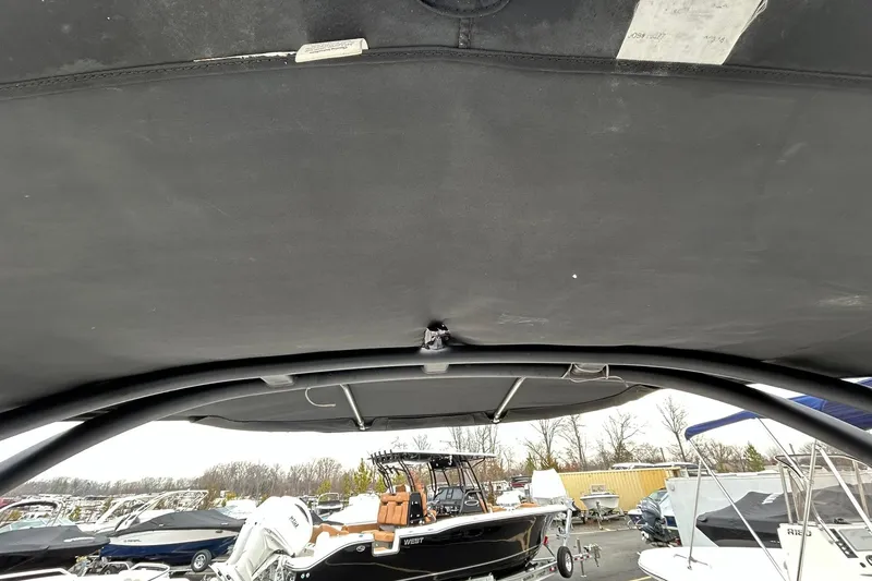 Slide: The Image of 2019 Yamaha Boats AR190 with black canopy, parked among other boats. - 9