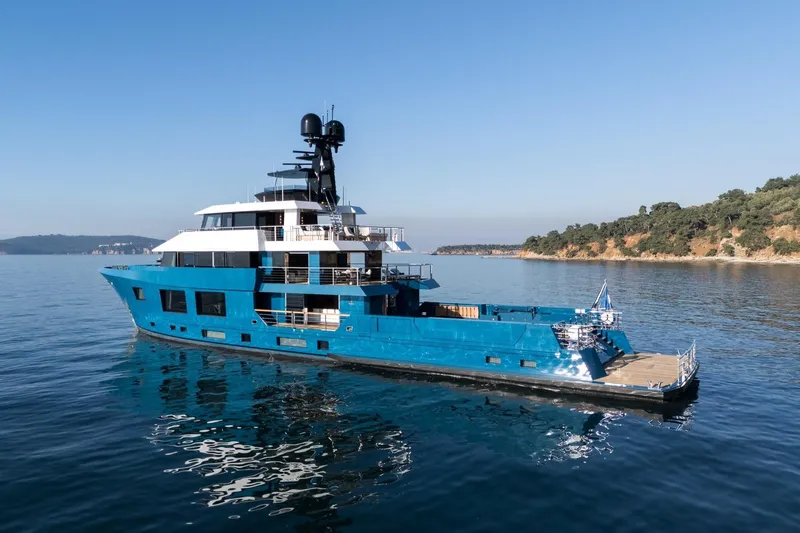 Slide: The Image of 2024 Dunya Yachts Explorer cruising near rocky outcrop in open sea. - 1