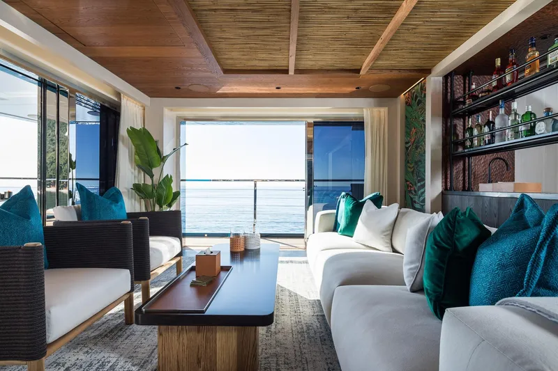 Slide: The Image of 2024 Dunya Yachts Explorer cruising alongside a smaller boat in scenic waters. - 6