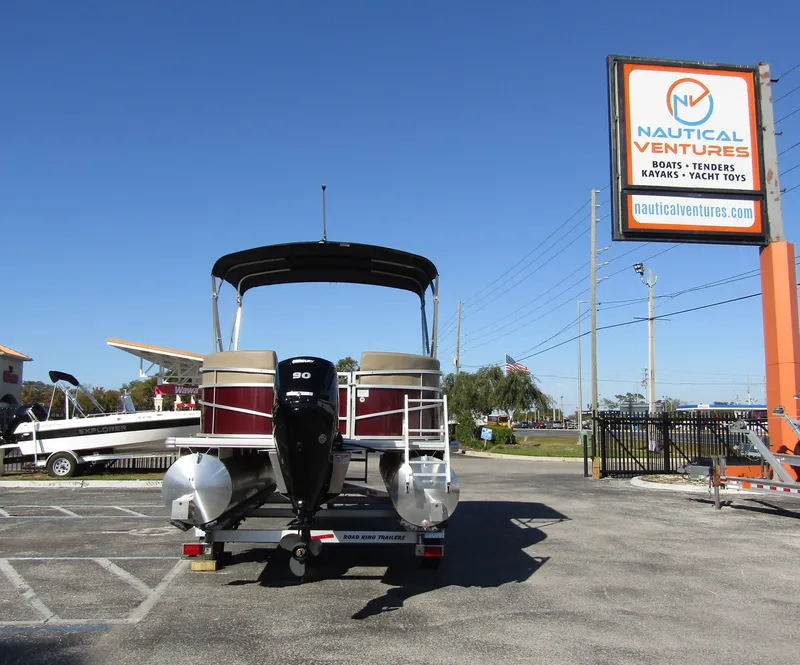 Slide: The Image of 2024 Starcraft LX 20 R pontoon boat at Nautical Ventures dealership. - 2