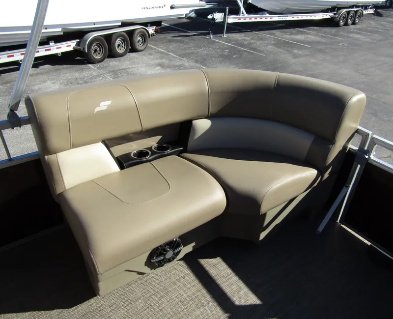 Slide: The Image of 2024 Starcraft LX 20 R boat seating with cup holders, beige upholstery, and speaker. - 20