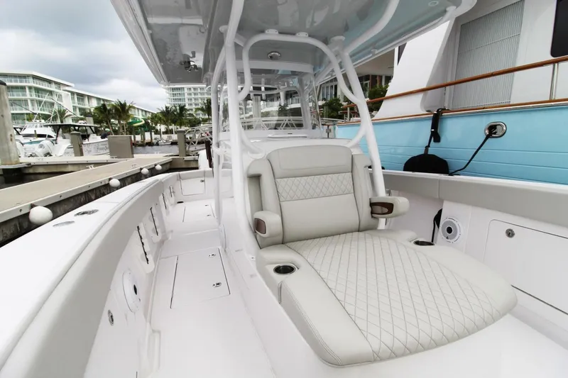 Slide: The Image of 2024 Jupiter 34 HFS boat with luxurious seating at a marina. - 10