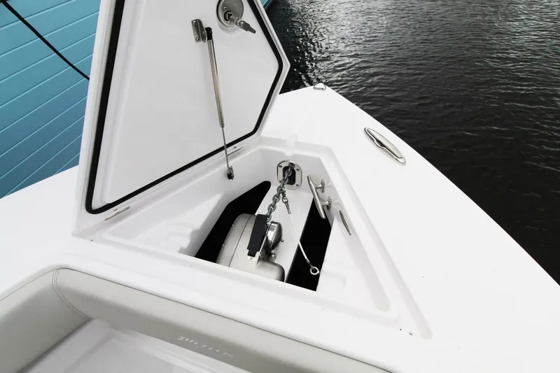 Slide: The Image of 2024 Jupiter 34 HFS boat anchor compartment open, showing anchor and chain storage. - 12