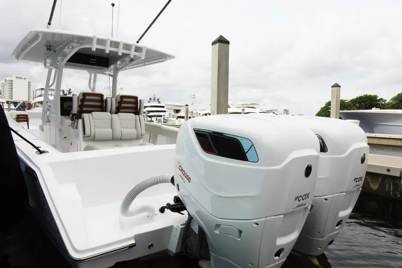 Slide: The Image of 2024 Jupiter 34 HFS boat with dual outboard engines docked at marina. - 14