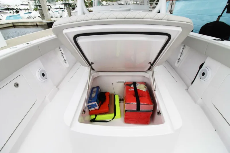 Slide: The Image of Open storage compartment on 2024 Jupiter 34 HFS boat with safety gear inside. - 17