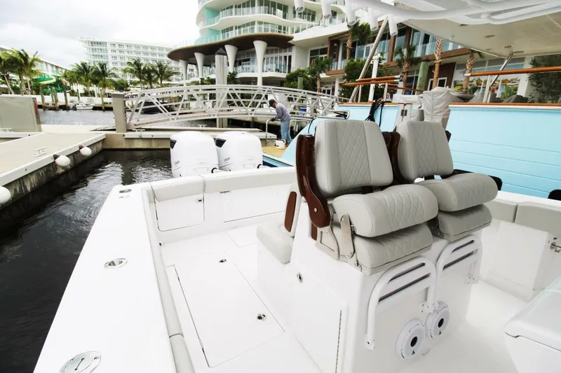 Slide: The Image of 2024 Jupiter 34 HFS boat with luxurious seating at a marina. - 2