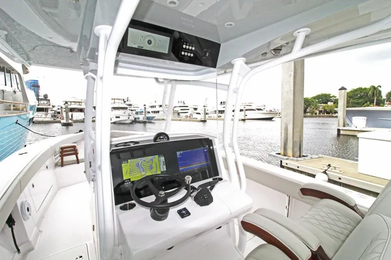 Slide: The Image of 2024 Jupiter 34 HFS boat cockpit with advanced navigation system at marina. - 6