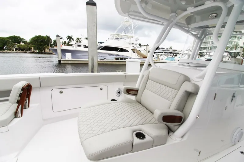 Slide: The Image of 2024 Jupiter 34 HFS boat with luxurious seating at a marina. - 9