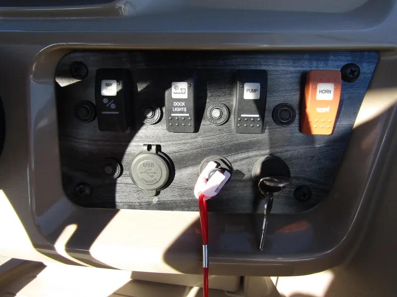 Slide: The Image of Control panel of 2024 Starcraft LX 20 R boat with switches and key ignition. - 15