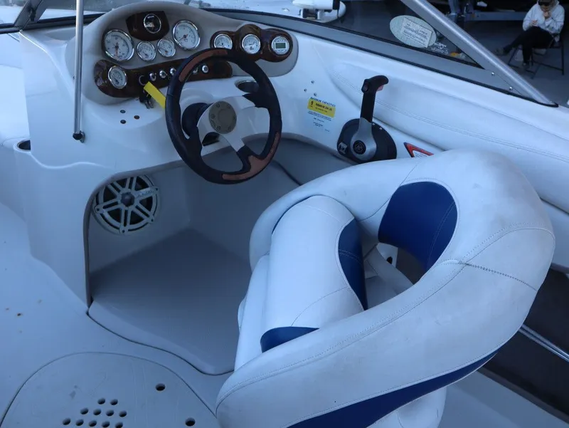 Slide: The Image of Interior of a 2010 Tahoe Q71 21 boat with steering wheel and seat. - 9