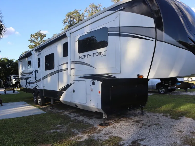 Slide: The Image of 2023 JAYCO North Point 382FLRB RV on campsite. - 16