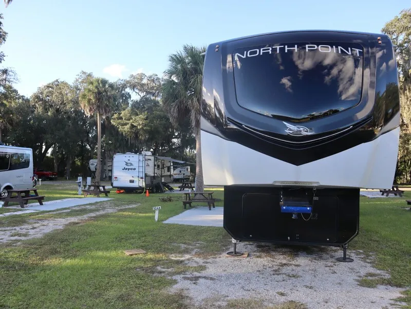 Slide: The Image of 2023 JAYCO North Point 382FLRB RV at a campsite. - 17