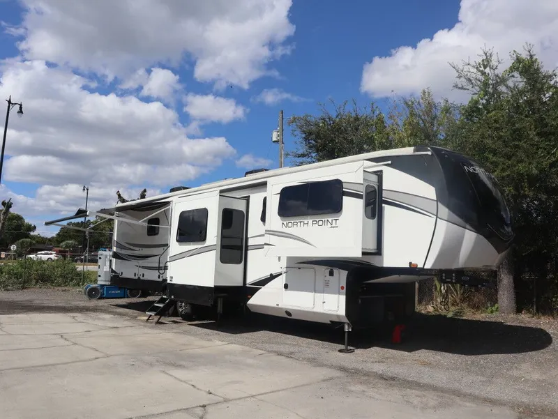 Slide: The Image of 2023 JAYCO North Point 382FLRB RV under blue sky. - 19