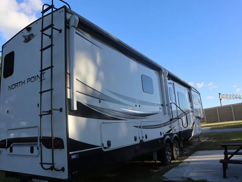 Slide: The Image of 2023 JAYCO North Point 382FLRB RV parked at a campsite. - 3