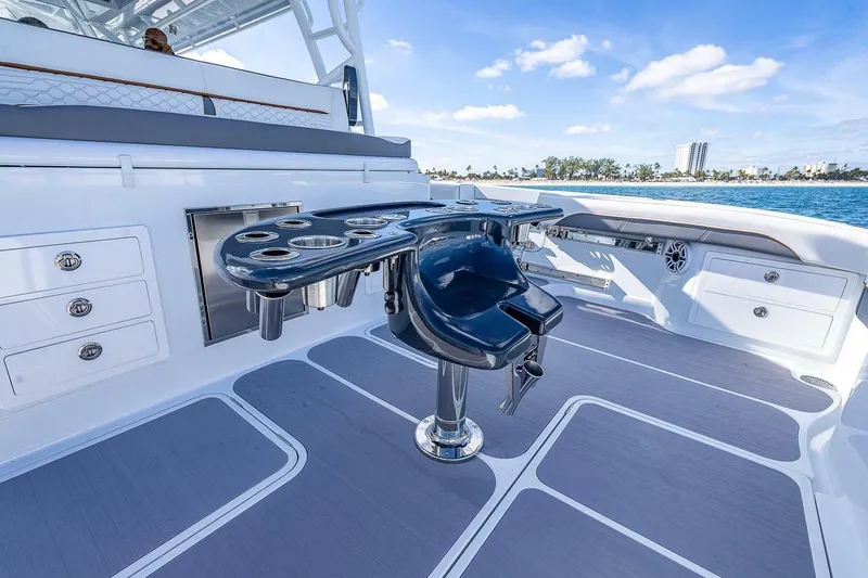 Slide: The Image of 2024 Yellowfin 54 Offshore boat deck with fishing rod holders and storage compartments. - 18