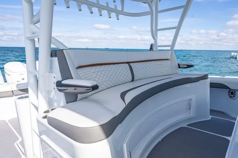 Slide: The Image of 2024 Yellowfin 54 Offshore boat interior with luxurious seating and ocean view. - 22