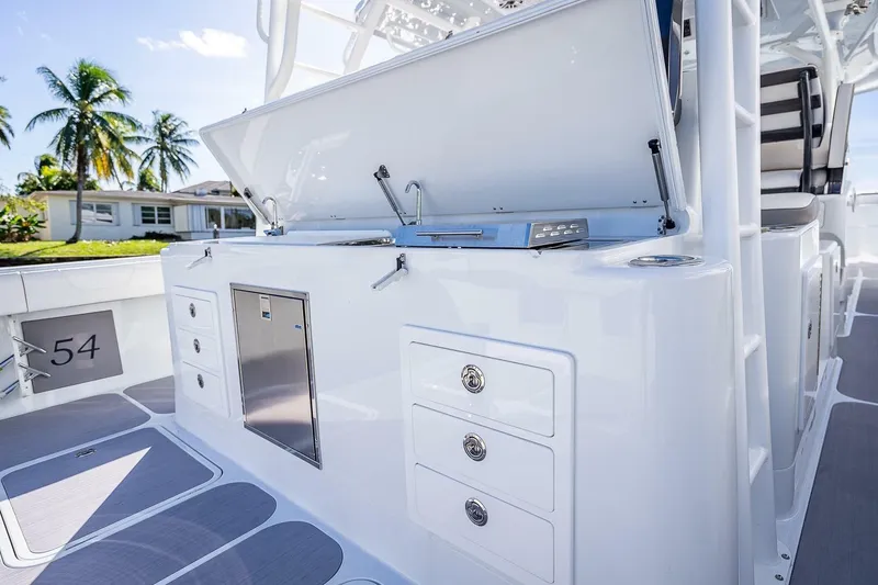 Slide: The Image of 2024 Yellowfin 54 Offshore boat interior with storage compartments and sleek design. - 37