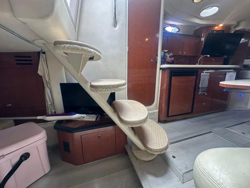 Slide: The Image of Interior of 2004 Sea Ray 340 Sundancer with stairs, kitchenette, and seating area. - 24