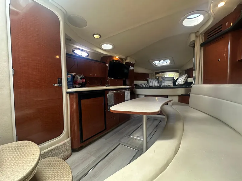 Slide: The Image of Interior of 2004 Sea Ray 340 Sundancer yacht with modern amenities and cozy seating. - 28
