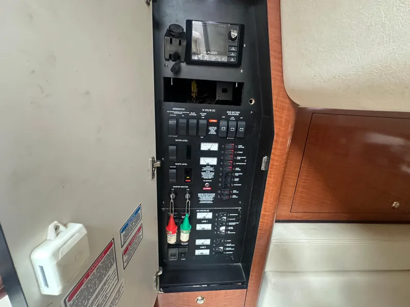 Slide: The Image of Electrical panel inside a 2004 Sea Ray 340 Sundancer boat, featuring various switches and controls. - 41