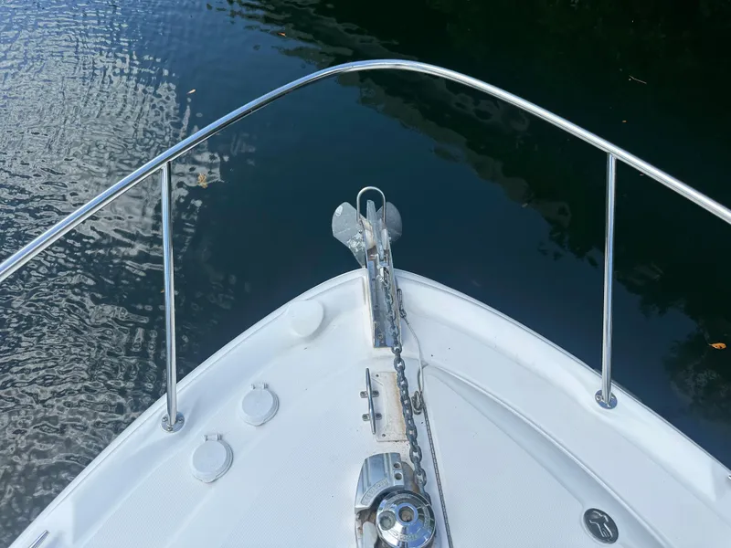 Slide: The Image of Bow of 2004 Sea Ray 340 Sundancer yacht with anchor, on calm water. - 8