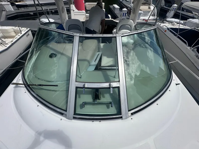 Slide: The Image of 2004 Sea Ray 340 Sundancer boat with sleek windshield and spacious cockpit. - 9