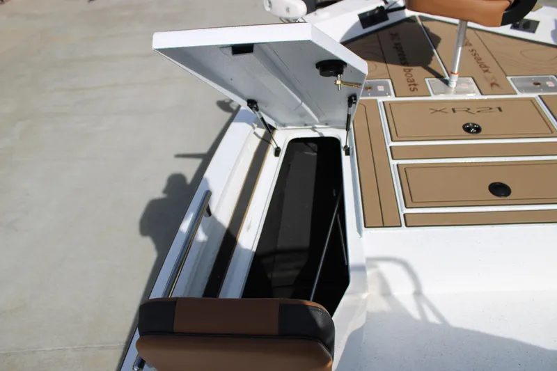 Slide: The Image of 2026 Xpress XR21B Bay boat with open storage compartment and seating. - 11